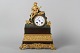 Antique Mental clock with playing man in Bronze and partly gilded